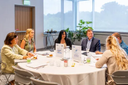 Conference attendees speaking around their table
