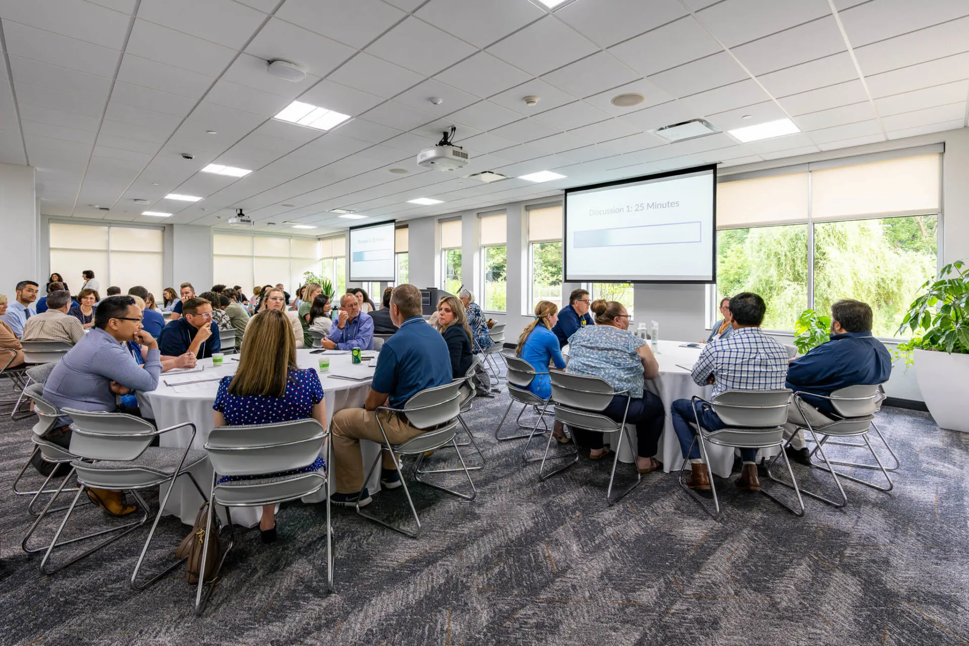 Conference attendees speaking around their table