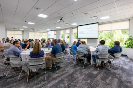 Conference attendees speaking around their table
