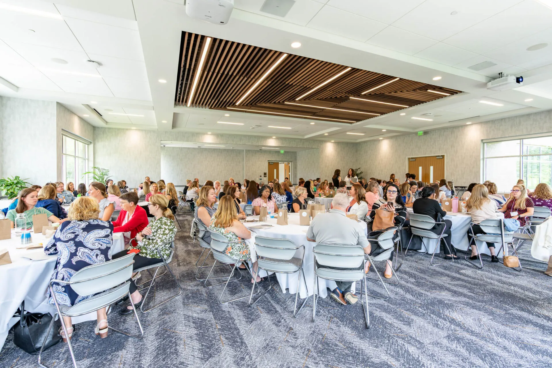 Conference attendees speaking around their table