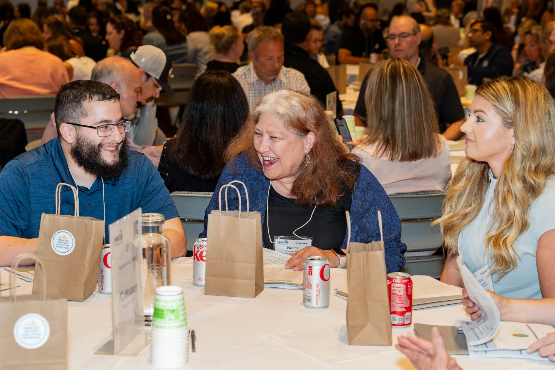 Conference attendees speaking around their table