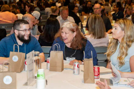 Conference attendees speaking around their table