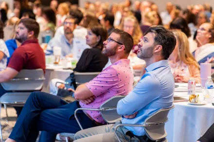Members of the audience looking up to the presentation